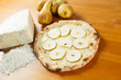 Italian Pizza, ingredients in the background on a wood table