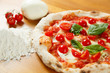 Quadro Typical Italian Pizza, ingredients in background on wood table Quadro Typical Italian Pizza, ingredients in background on wood table