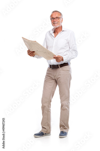 Photo: Casual senior man with newspaper, looking to camera Casual senior man with newspaper, looking to camera