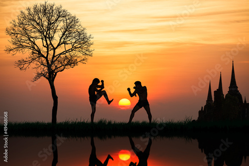 Fototapeta na wymiar Silhouette of a thai's boxing at sunset