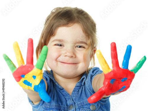 Photo: Cute little girl is proud of her coloured hands Cute little girl is proud of her coloured hands