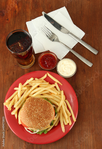 Photo: Tasty cheeseburger with fried potatoes and cold drink, Tasty cheeseburger with fried potatoes and cold drink,