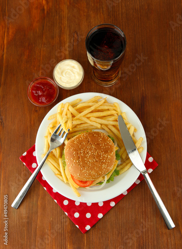 Photo: Tasty cheeseburger with fried potatoes and cold drink, Tasty cheeseburger with fried potatoes and cold drink,