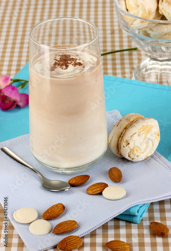Photo: Glass of chocolate-cream cocktail on beige tablecloth close-up Glass of chocolate-cream cocktail on beige tablecloth close-up