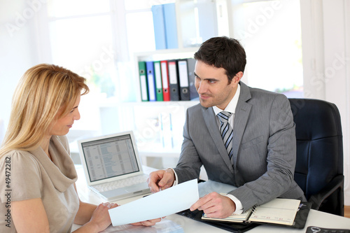 Photo: Woman meeting banker to set up her own business Woman meeting banker to set up her own business