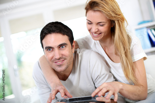 Photo: Couple at home playing video games Couple at home playing video games