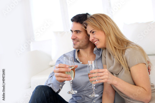 Photo: Romantic couple drinking wine at home Romantic couple drinking wine at home