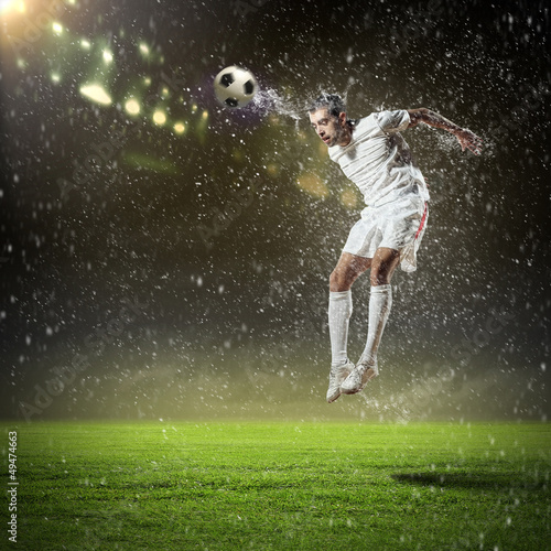 Photo: football player striking the ball football player striking the ball