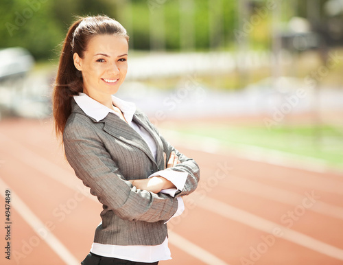 Photo: Business woman at athletic stadium Business woman at athletic stadium