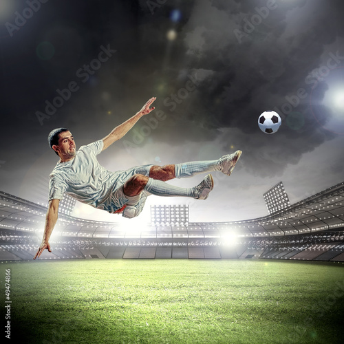 Photo: football player striking the ball football player striking the ball