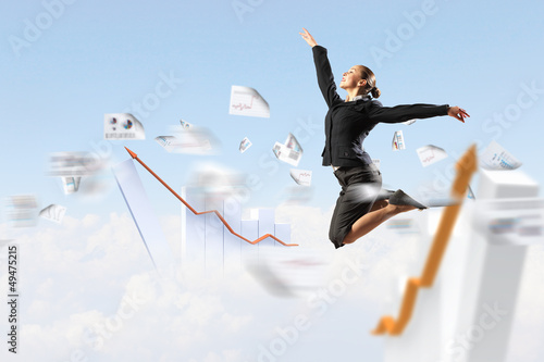 Photo: businesswoman in black suit jumping businesswoman in black suit jumping