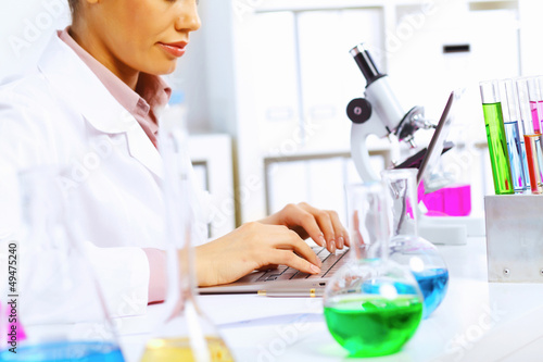 Photo: Young female scientist working in laboratory Young female scientist working in laboratory