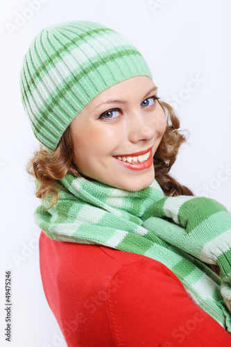 Photo: Young woman wearing winter hat and warm scarf Young woman wearing winter hat and warm scarf