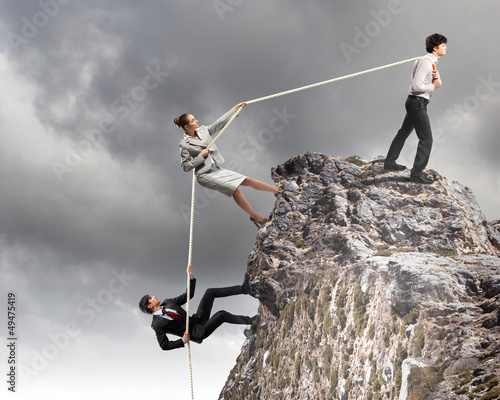 Photo: Three business people pulling rope Three business people pulling rope