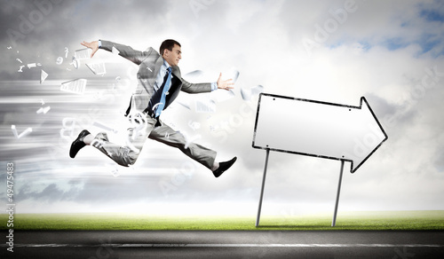 Photo: Businessman running on the road Businessman running on the road