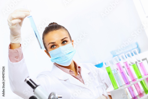 Photo: Young female scientist working in laboratory Young female scientist working in laboratory