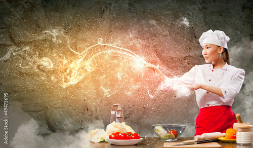 Photo: Asian female cooking with magic Asian female cooking with magic