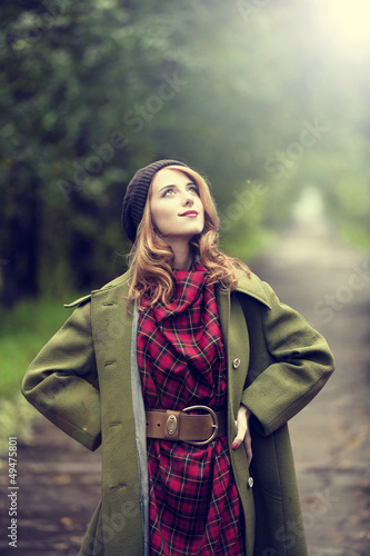 Photo: Style redhead girl at beautiful autumn alley. Style redhead girl at beautiful autumn alley.