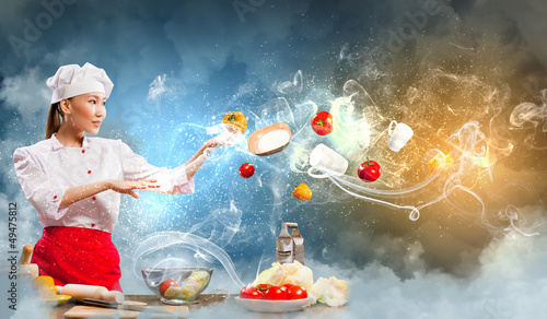 Photo: Asian female cooking with magic Asian female cooking with magic