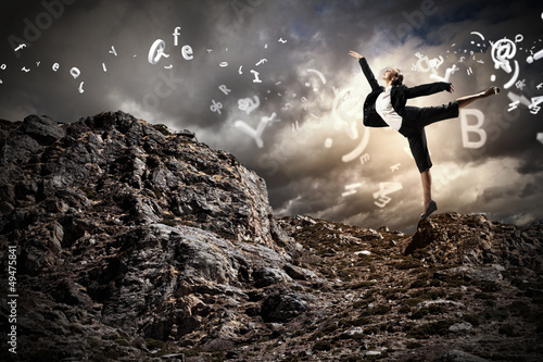Photo: businesswoman standing atop of mountain businesswoman standing atop of mountain