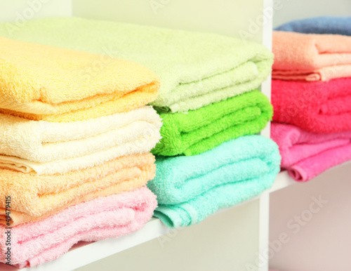 Photo: colorful towels on shelves in bathroom colorful towels on shelves in bathroom