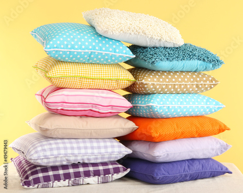 Photo: Hill colorful pillows on yellow background Hill colorful pillows on yellow background