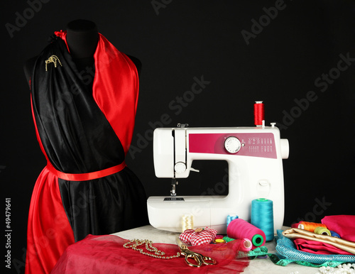 Photo: Sewing machine, dummy and other sewing equipment isolated Sewing machine, dummy and other sewing equipment isolated