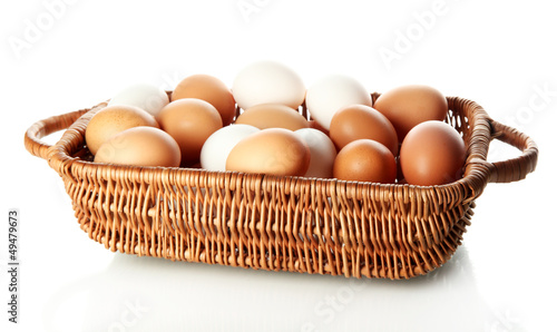 Photo: Many eggs in basket isolated on white Many eggs in basket isolated on white