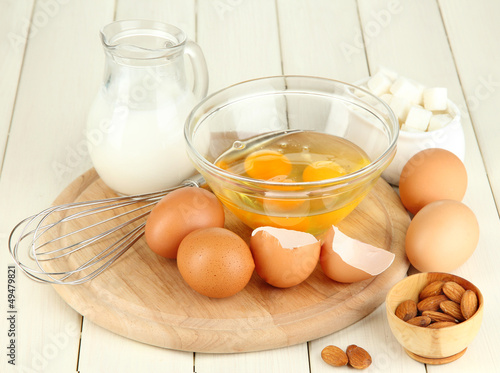Photo: Broken egg in bowl and various ingredients next to them Broken egg in bowl and various ingredients next to them
