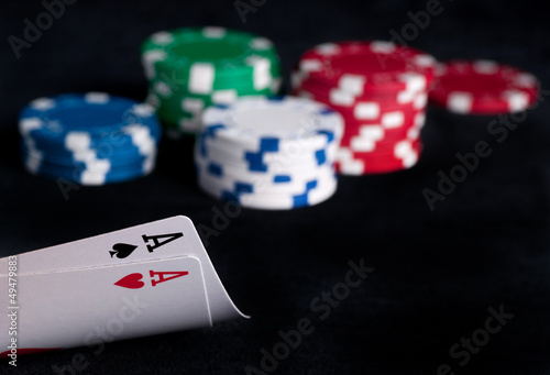 Photo: two aces high on black table with chips two aces high on black table with chips