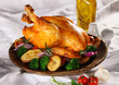 Roasted whole chicken on a plate with vegetables