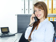 Female office assistant has a call at the office