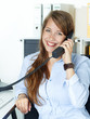 Foto: Female office assistant has fun to call a customer Female office assistant has fun to call a customer