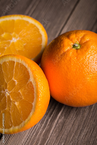 Photo: Close-up of orange fruit on wooden table. Close-up of orange fruit on wooden table.