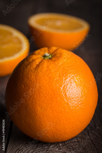 Photo: Close-up of orange fruit on wooden table. Close-up of orange fruit on wooden table.