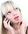 Photo: Attractive blond girl pondering while phoning Attractive blond girl pondering while phoning