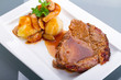 Photo: Roast pork with gravy and potatoes on the plate Roast pork with gravy and potatoes on the plate