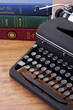 Typewriter and stack of books, close up