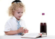 Cute young blond toddler jewish boy playing pretend