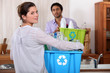 Man and woman preparing to recycle plastic bottles