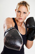 Portrait of a female boxer punching