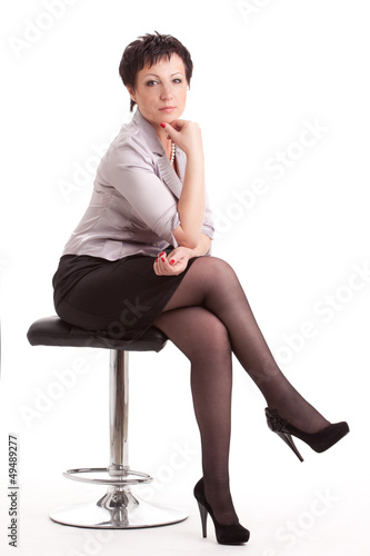 Photo: adult businesswoman sitting on chair over white adult businesswoman sitting on chair over white