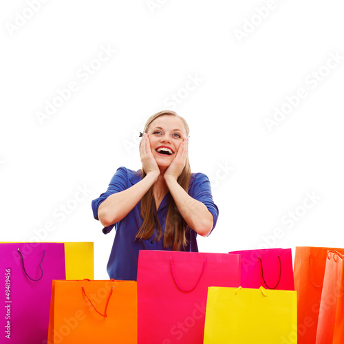 Photo: happy woman behind shopping bags happy woman behind shopping bags