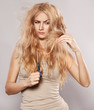 Young woman looking at split ends