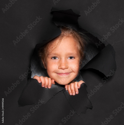 Photo: Kid looking out of a hole Kid looking out of a hole