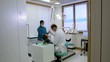 Dentist and assistant checking dental hygiene of client