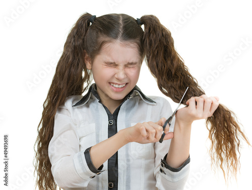 Photo: schoolgirl scissors cuts her hair schoolgirl scissors cuts her hair