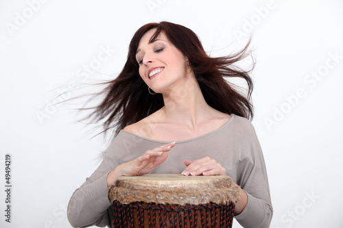 Photo: Woman playing bongo Woman playing bongo