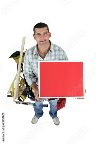 Photo: Carpenter posing with a picture frame Carpenter posing with a picture frame