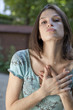 Photo: young woman touching her heart for consent young woman touching her heart for consent